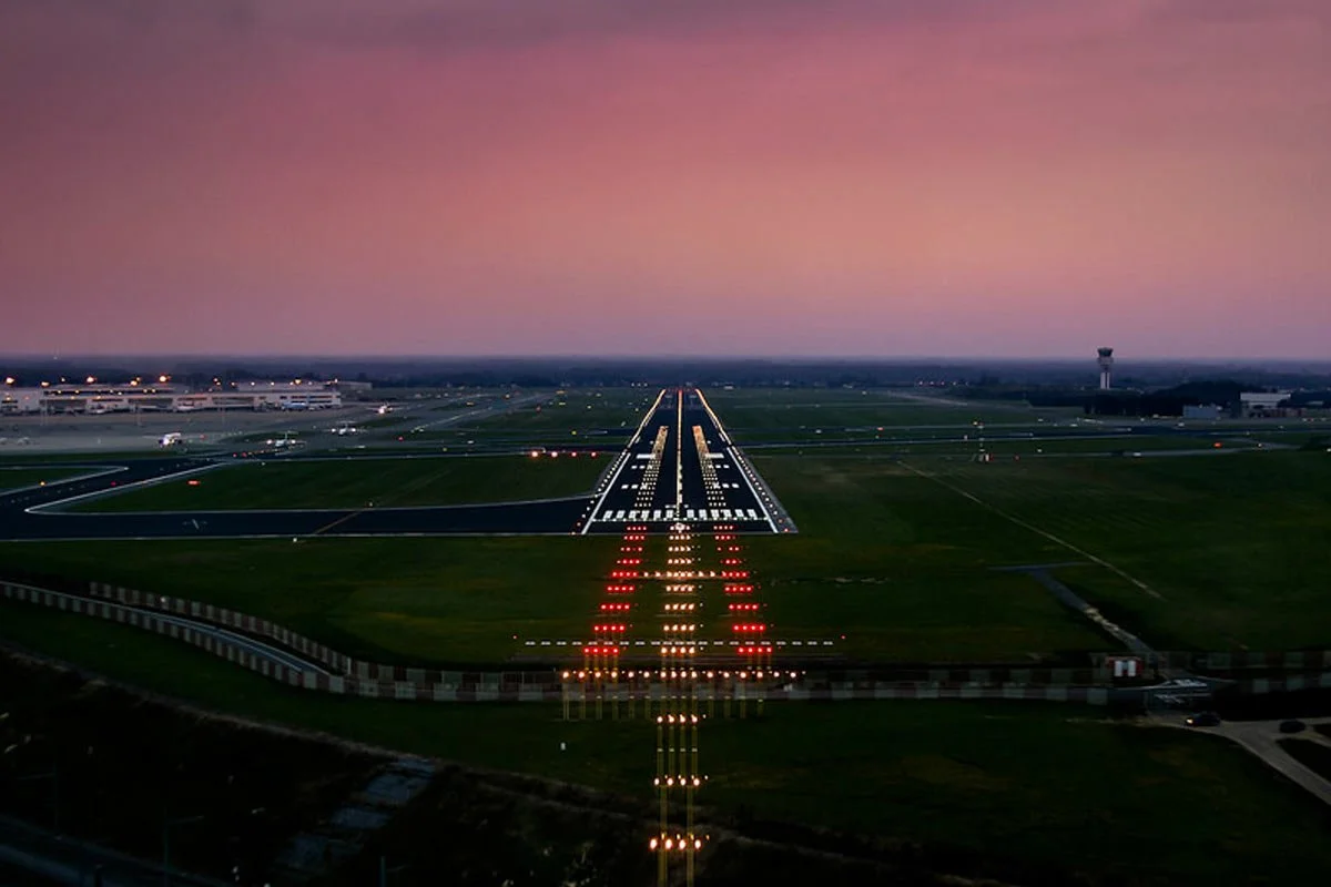 Runway approach lights at McKinney National Airport at dusk