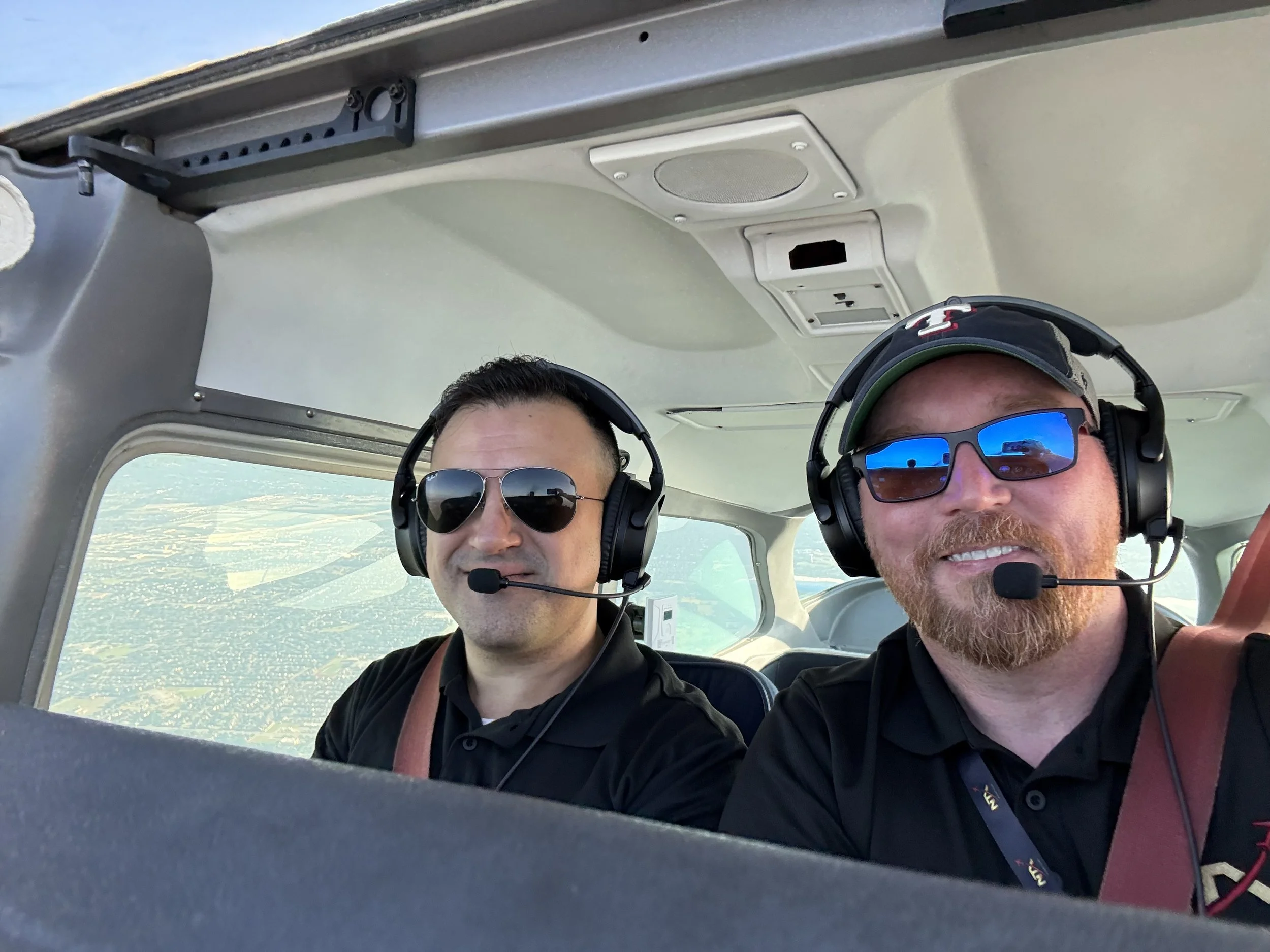 Instructor briefing a student beside a Cessna 172
